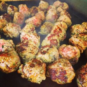 Meatballs frying in a pan